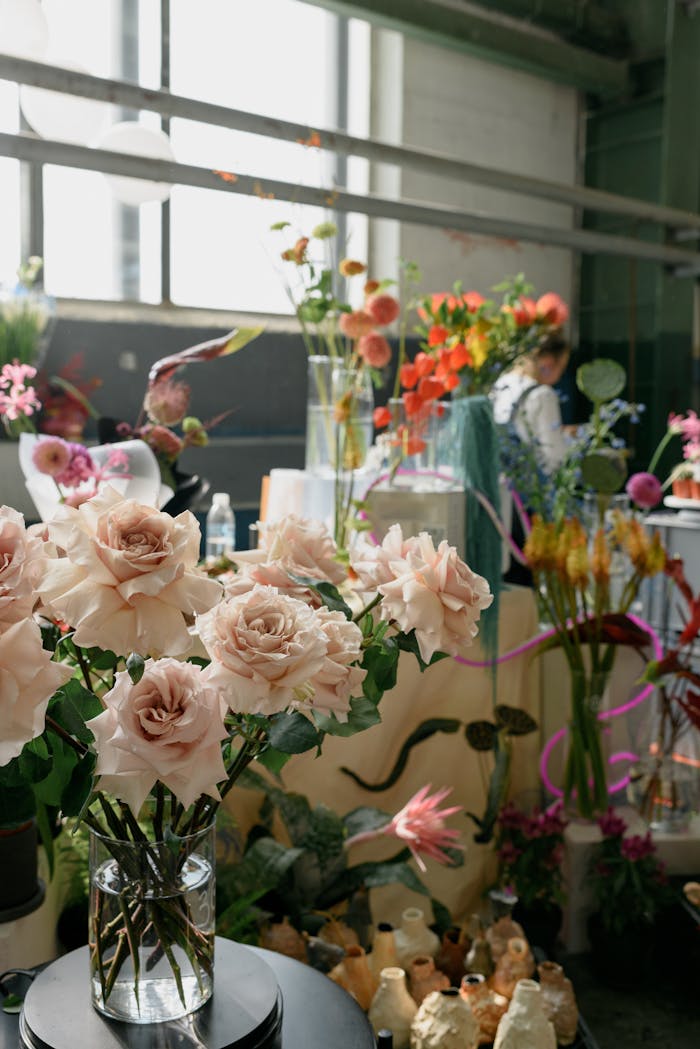 Beautiful indoor floral display with elegant roses and diverse flowers in a modern setting. Bright ambiance.
